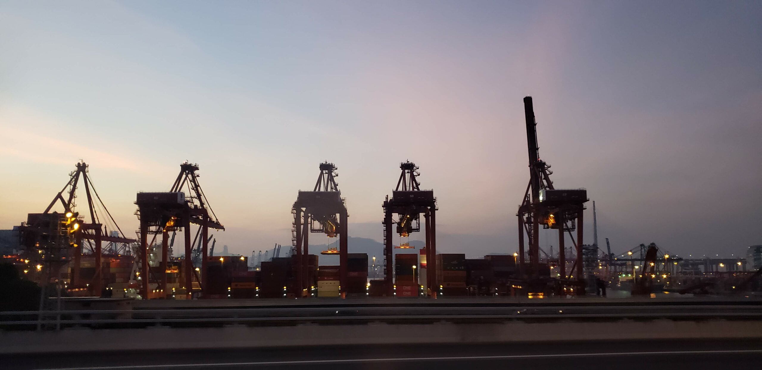silhouettes of cranes in the port of Hong Kong